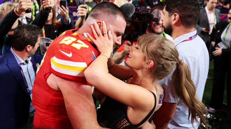 Taylor Swift tenant le visage de Travis Kelce sur le terrain