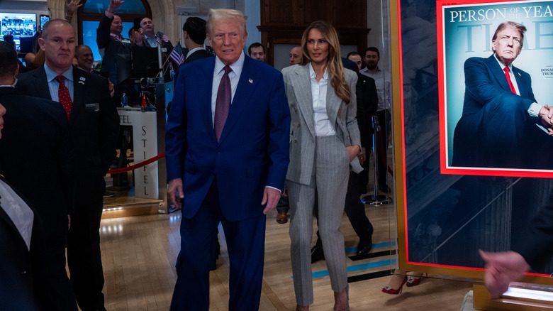 Melania Trump dans un tailleur-pantalon Ralph Lauren marchant derrière Donald Trump