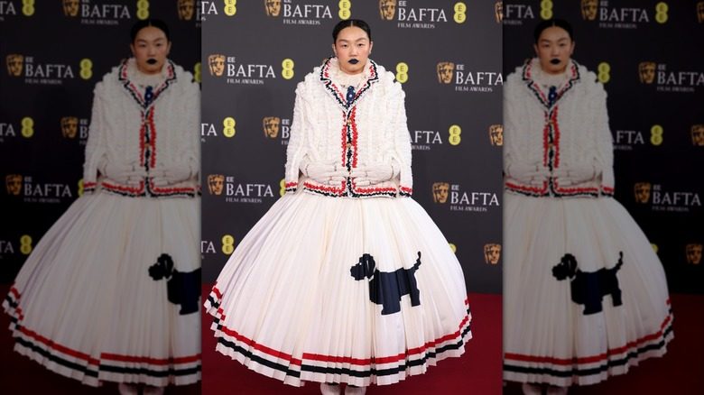 Audrey Nuna se tient sur le tapis rouge pendant que des photos sont prises