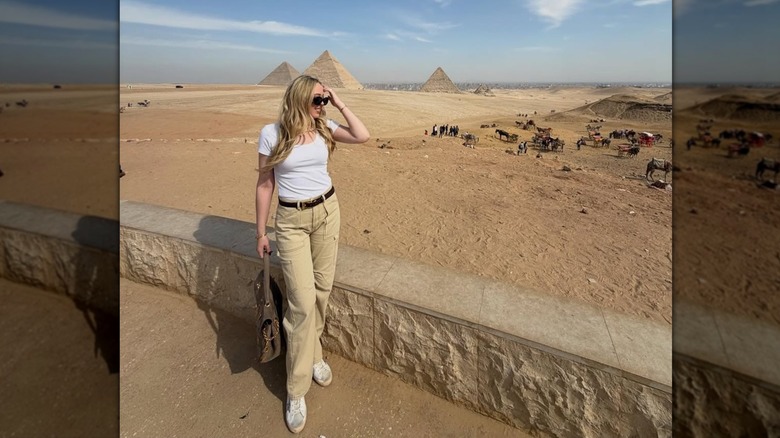 Tiffany Trump posant dans un t-shirt blanc et un pantalon cargo beige près des pyramides en Égypte