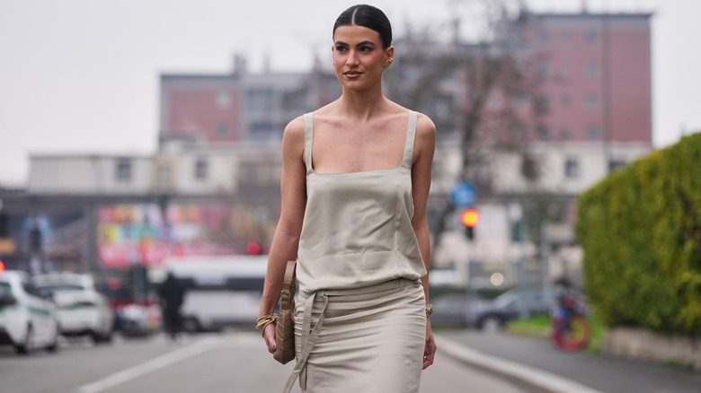 Une femme portant une robe beige ennuyeuse, tendance minimaliste