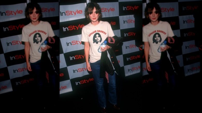 Winona Ryder posant lors d'un événement portant un jean et un T-shirt.