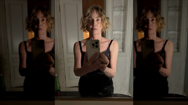 Sharon Stone pose pour un selfie miroir avec des cheveux en bataille et sans maquillage.