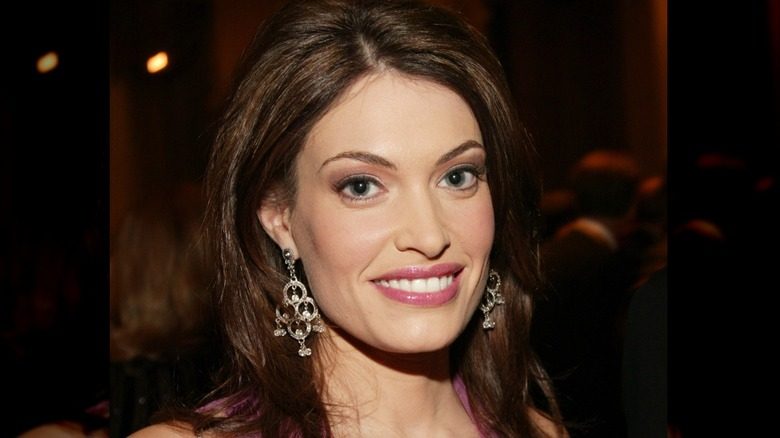 Kimberly Guilfoyle souriant lors d'un événement en 2003 portant des boucles d'oreilles pendantes.