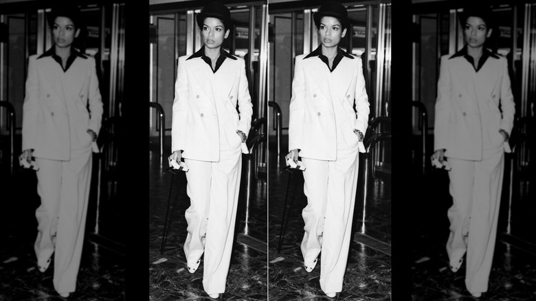 Bianca Jagger posant dans un costume blanc à l'aéroport d'Heathrow en 1972.