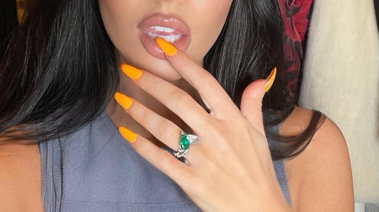 Stephen Webster Jewellery a publié ce selfie de Megan Fox sur Instagram en 2022 avec sa bague de fiançailles bien en vue sur sa main avec des ongles de couleur orange vif.