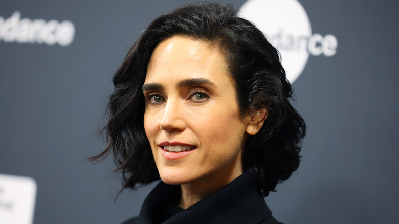 Jennifer Connelly sourit dans un col roulé noir