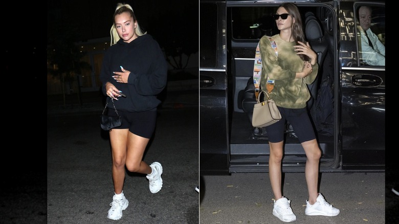 Anastasia Karanikolaou portant un sweat-shirt noir et un short motard avec des baskets blanches à Los Angeles en août 2019 / Vittoria Ceretti portant un sweat-shirt tie-dye et un short motard noir lors de la Fashion Week de Milan en septembre 2019