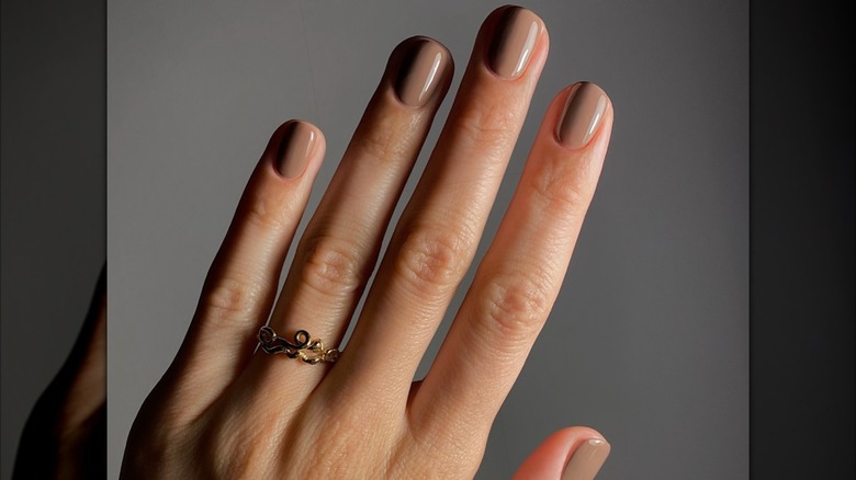 Femme aux ongles bordeaux