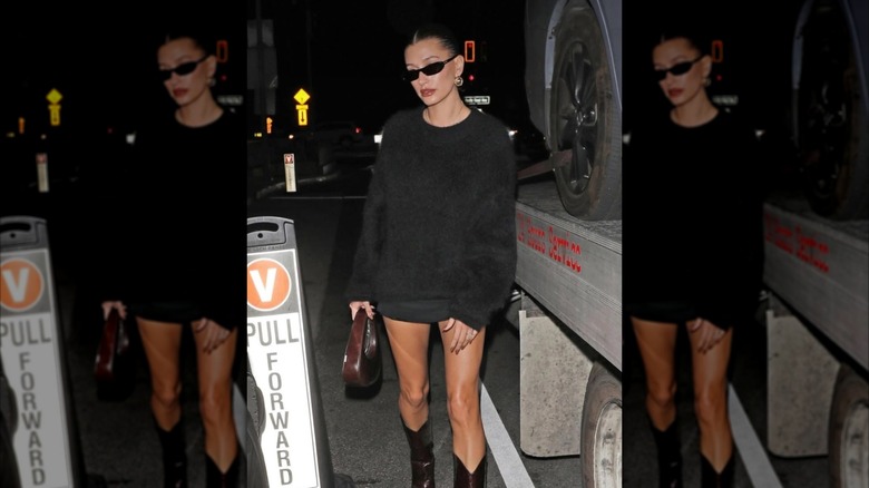 Hailey Bieber porte des lunettes de soleil fines.
