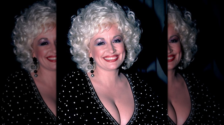 Dolly Parton en 1984 portant un haut noir orné de strass.