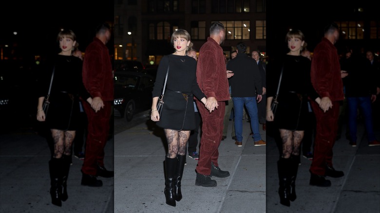 Taylor Swift porte un haut et une jupe noirs avec des collants à fleurs lors d'une sortie avec Travis Kelce